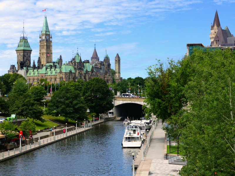 Boat lined Rideau Canal towards Parliament Hill in Ottawa.