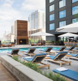 rooftop pool with cushioned loungers