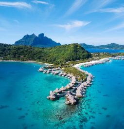 aerial view of overwater villa line with mountains