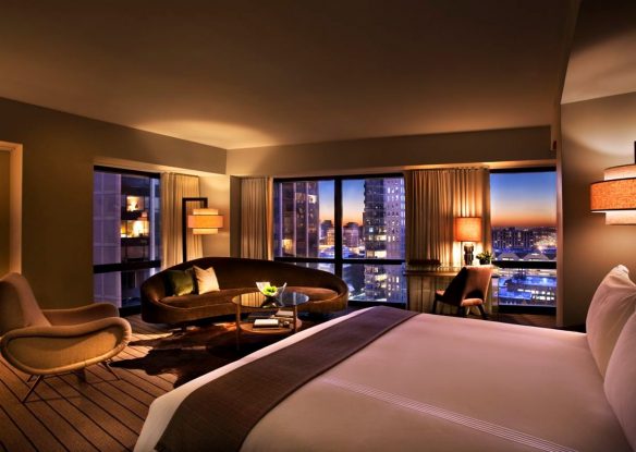 Sleek and moody hotel room with subtle lighting and city views