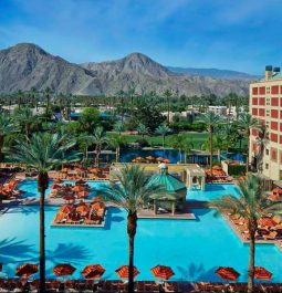 aerial view of resort pool in front of mountains