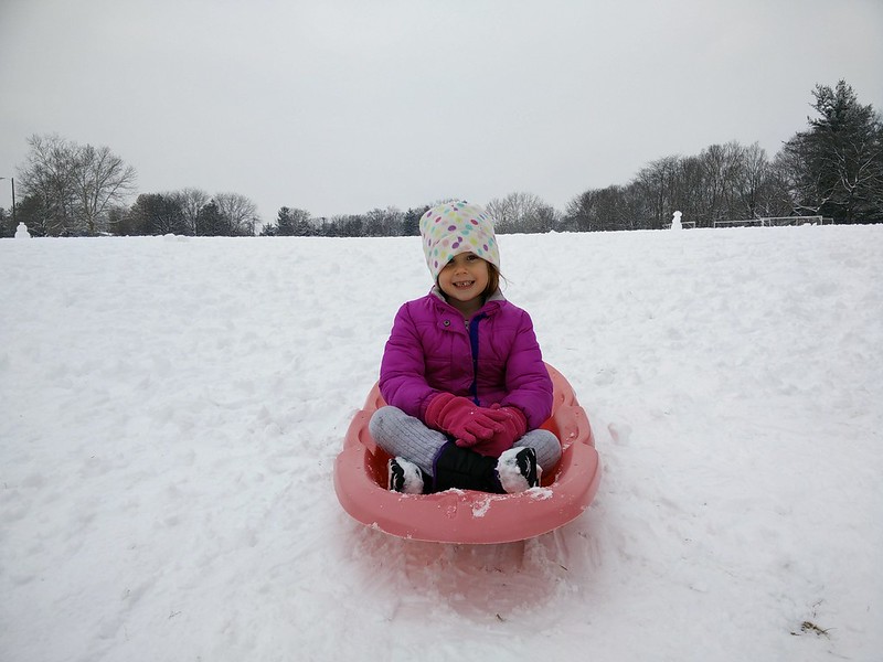 Young girl sledding