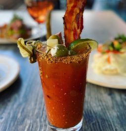 blood mary drink with food in background