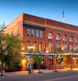 brick hotel at dusk with lights on