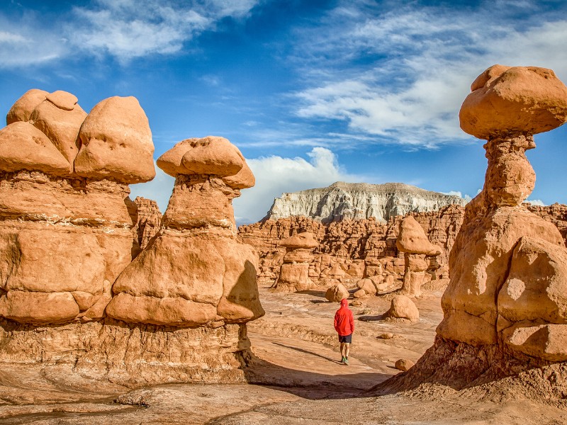 Hiking amidst stunning Hoodoos sandstone formations in Goblin Valley State Park.