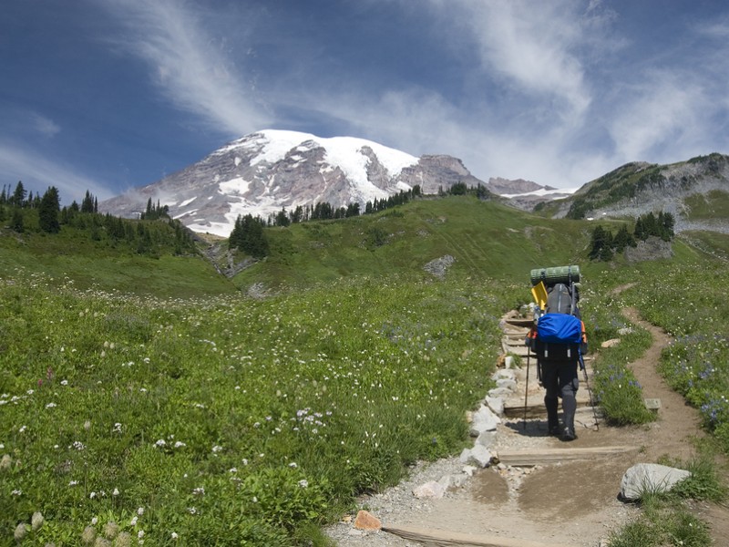 Backpacker beginning hike on trail in Mount Rainier National Park