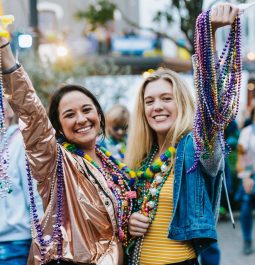 women with beads at Mardi Gras Galveston