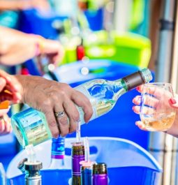 person pouring wine into a glass at neptune festival