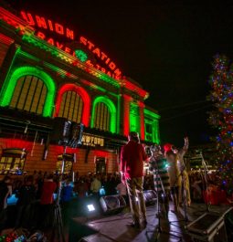 denver union station lit up with red and green lights at night