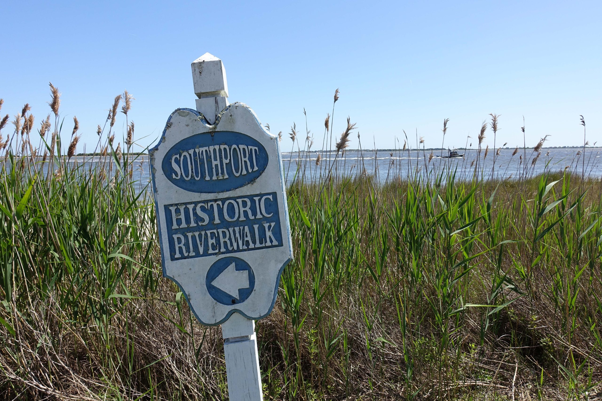 Weathered Historic Riverwalk Entrance Sign in Southport, NC