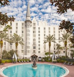 castle-like hotel with swimming pool with a fountain in the center