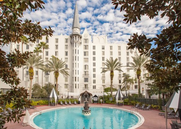 castle-like hotel with swimming pool with a fountain in the center