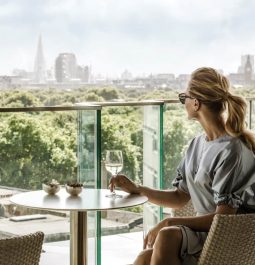 woman enjoying glass of wine on patio