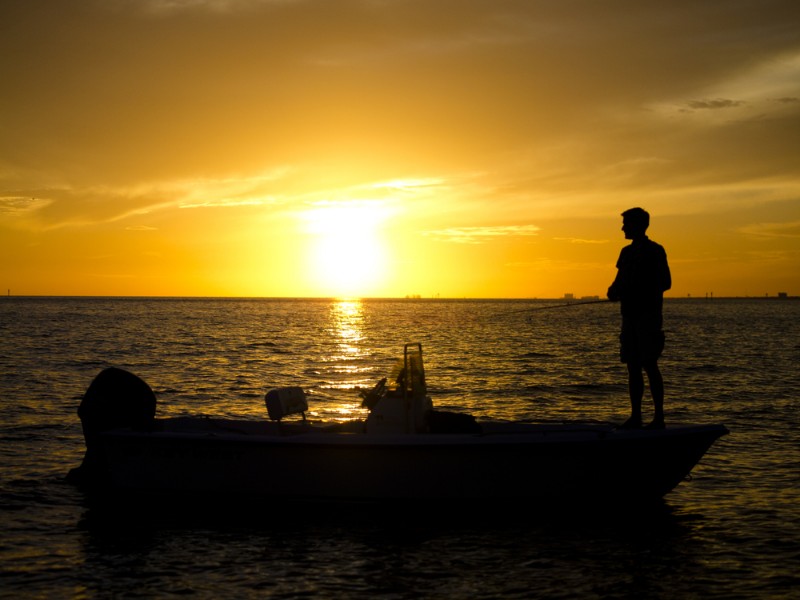 Man fishing at sunset 