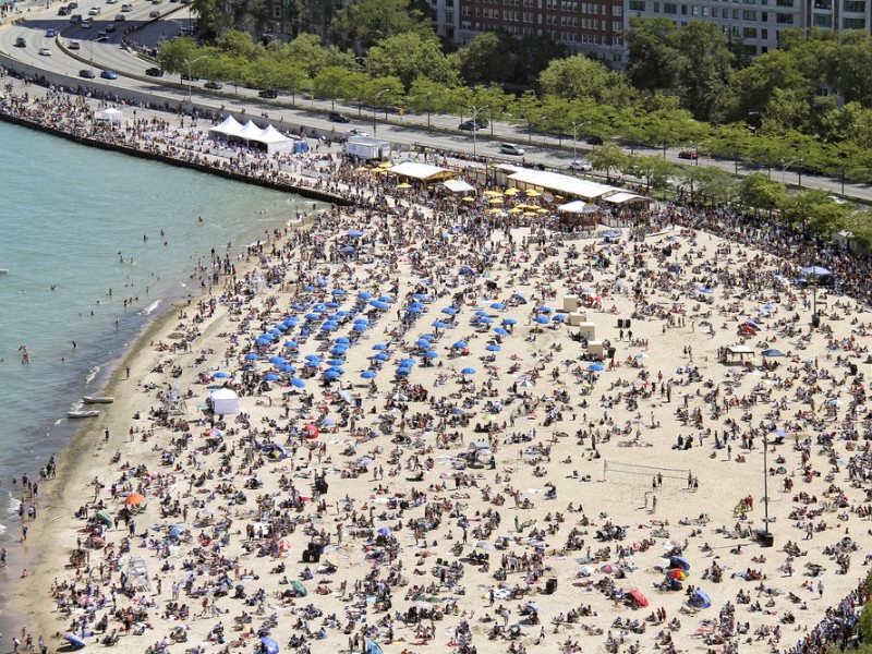 Crowded Oak Street beach in summer beside Lake Shore Drive in Chicago