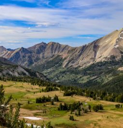 mountains with green pasture surrounding