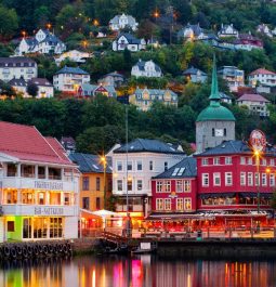 colorful buildings lit up along water