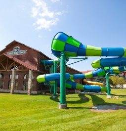 Lodge with twisty green and blue water slide sitting next to it