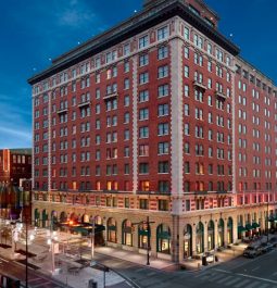 large omni severin hotel building lit up at night