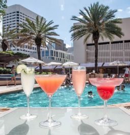 four drinks lined up along pool