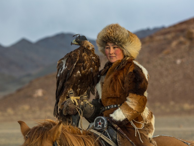 Golden Eagle Hunter teaches her young daughter in Western Mongolia