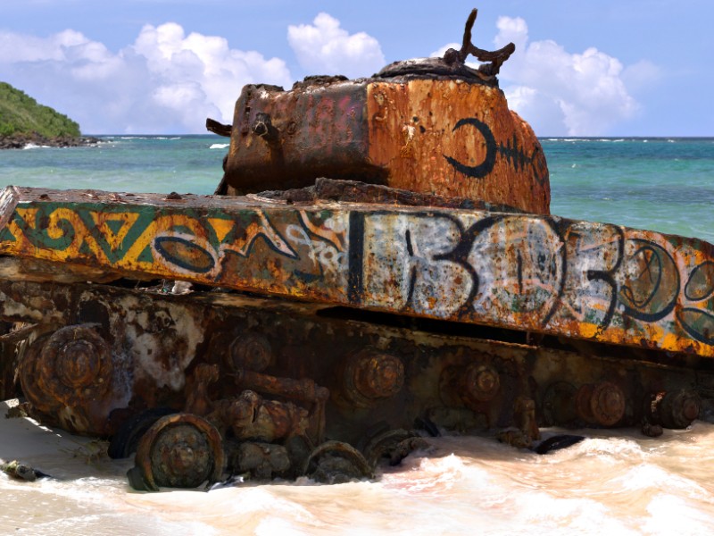 The old rusted and deserted US army tank of Flamenco beach