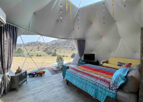 bed inside of a dome tent