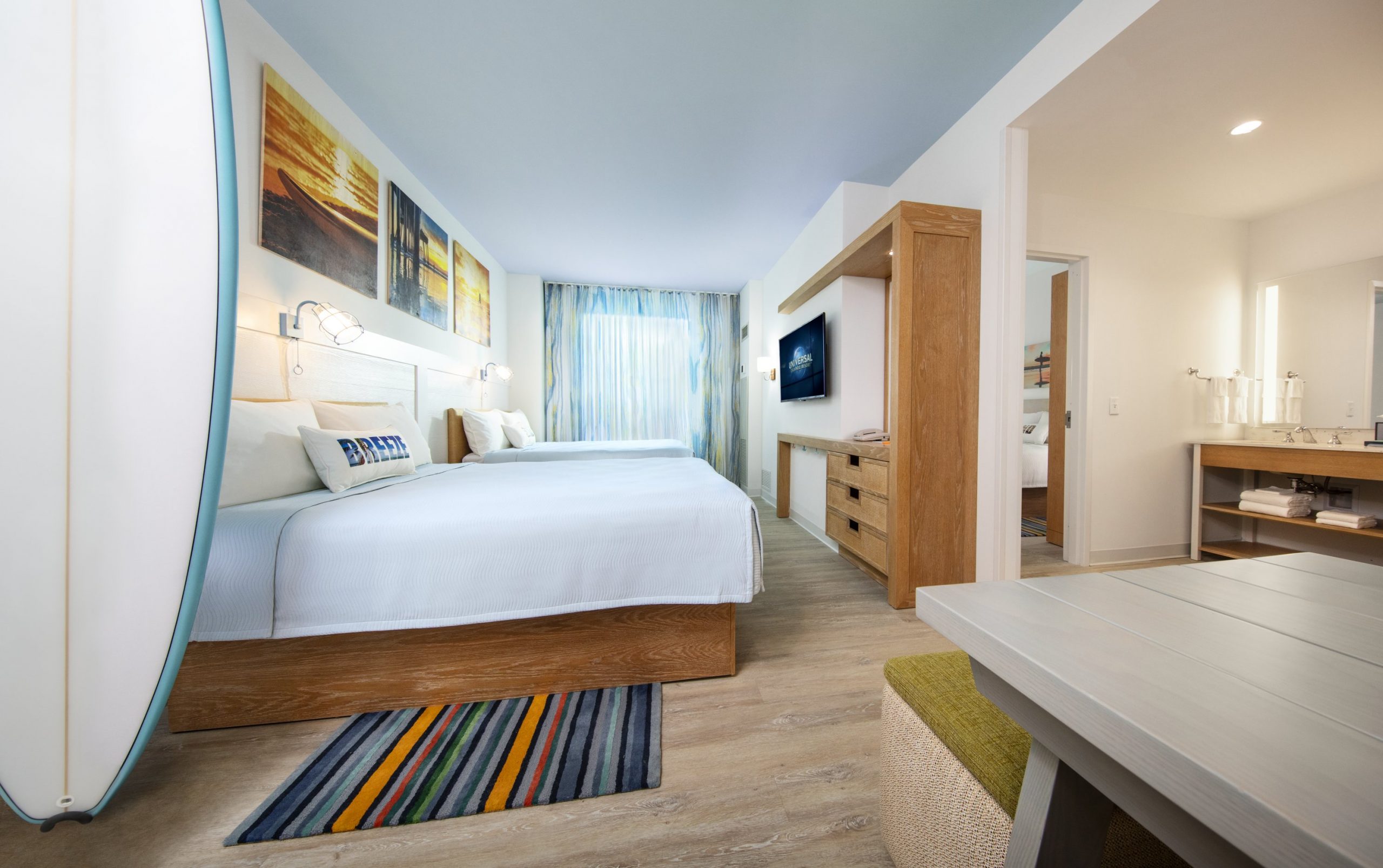 Each bedroom at Universal's Endless Summer - Dockside Inn & Suites has a decorative surfboard.