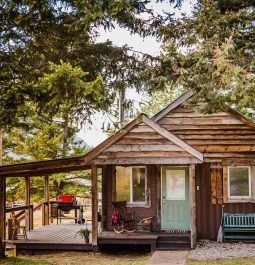 side view of wood cabin with front porch and outdoor area