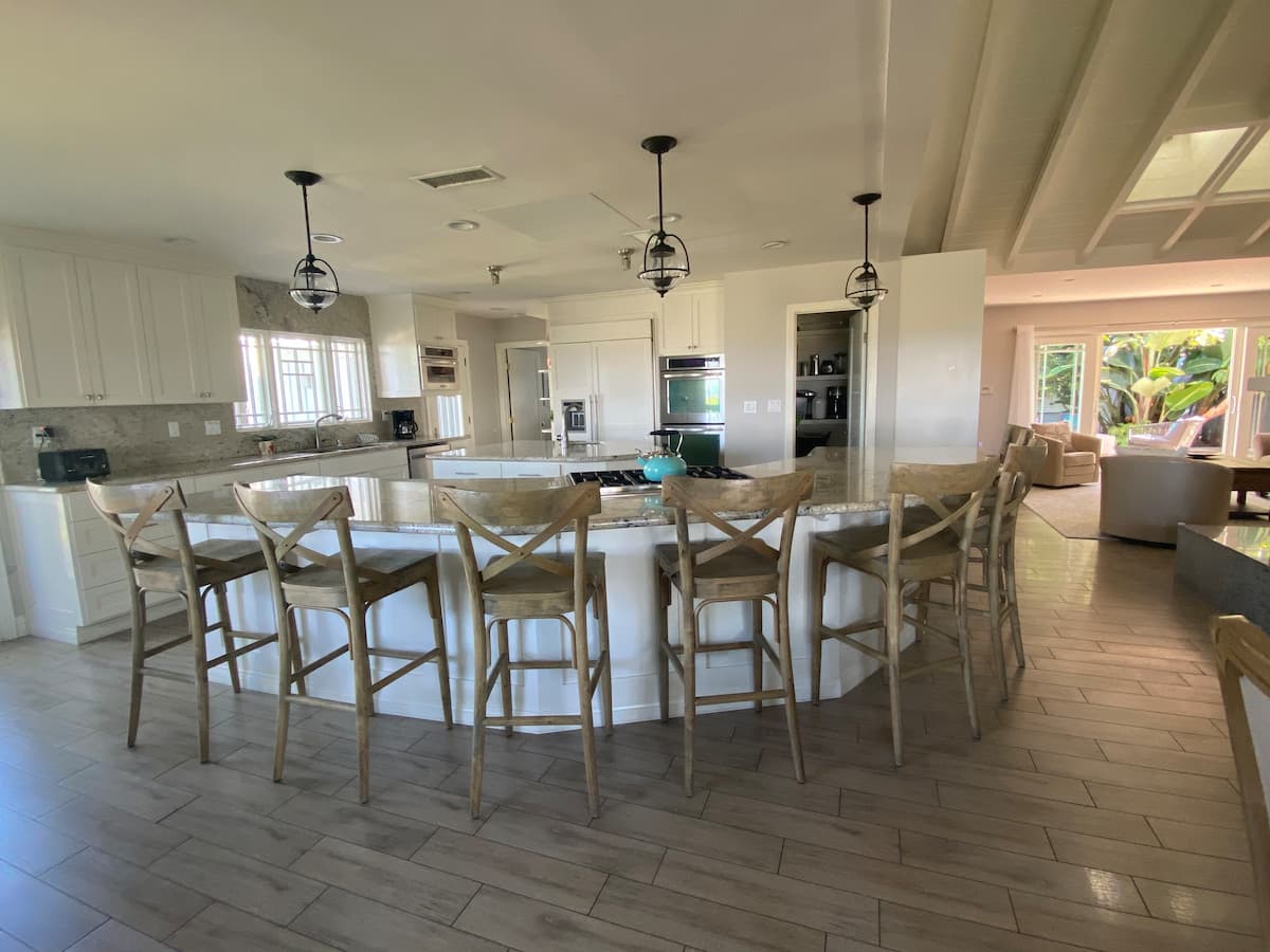 Open layout kitchen and bar with lots of seating at Dolphin Watch Beach House