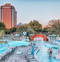 outdoor water play area with buildings in the backdrop