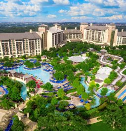 aerial view of resort with swimming pools and greenery