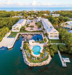 aerial view of islander resort with pool surrounded by water