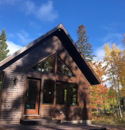 Exterior of cabin with trees in back