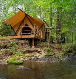 Tent view next to water and in woods