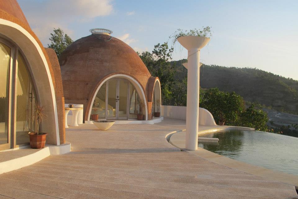 Santorini-esque dome house with pastel walls and infinity pool