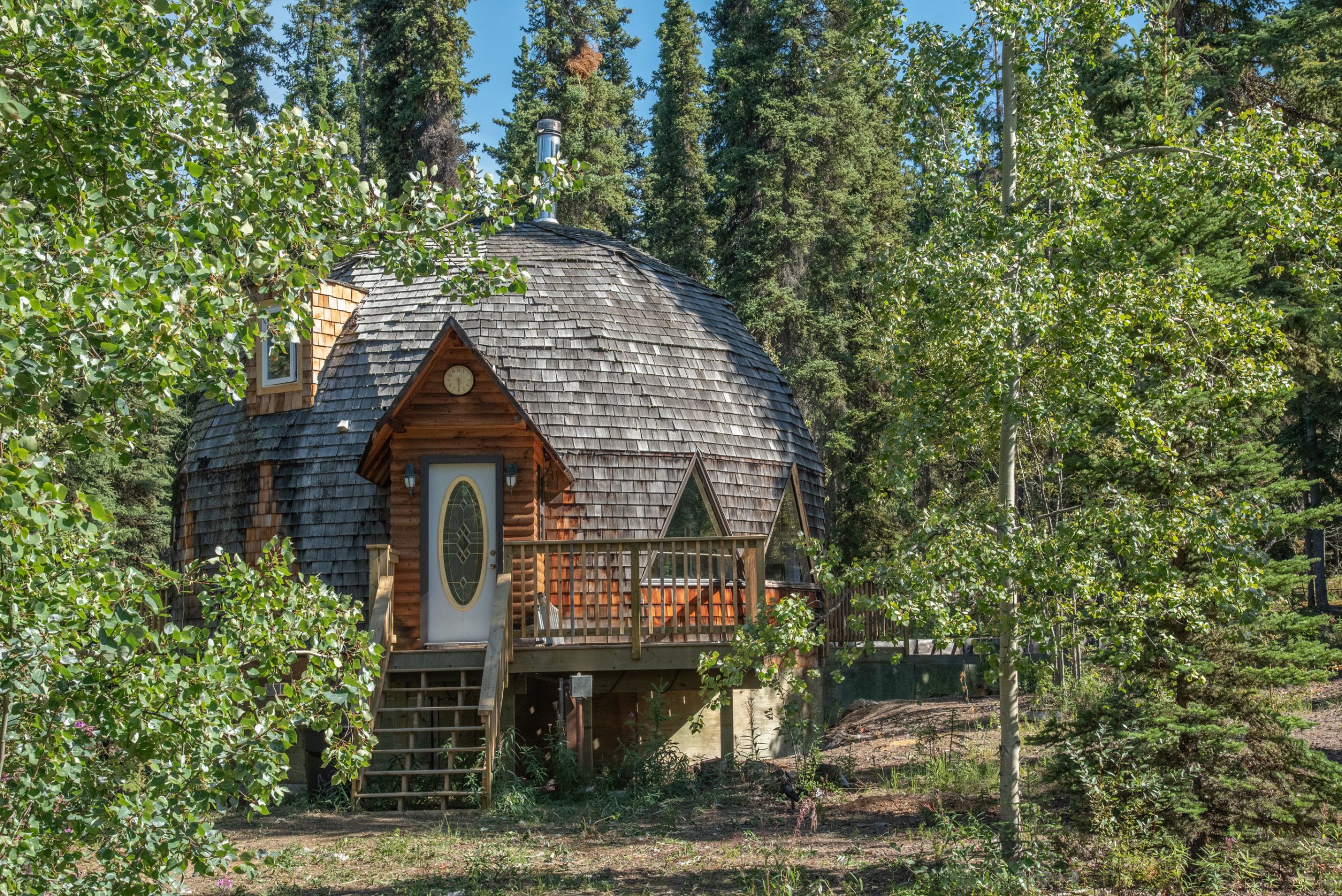 Wooden dome on stilts hidden deep in the forest