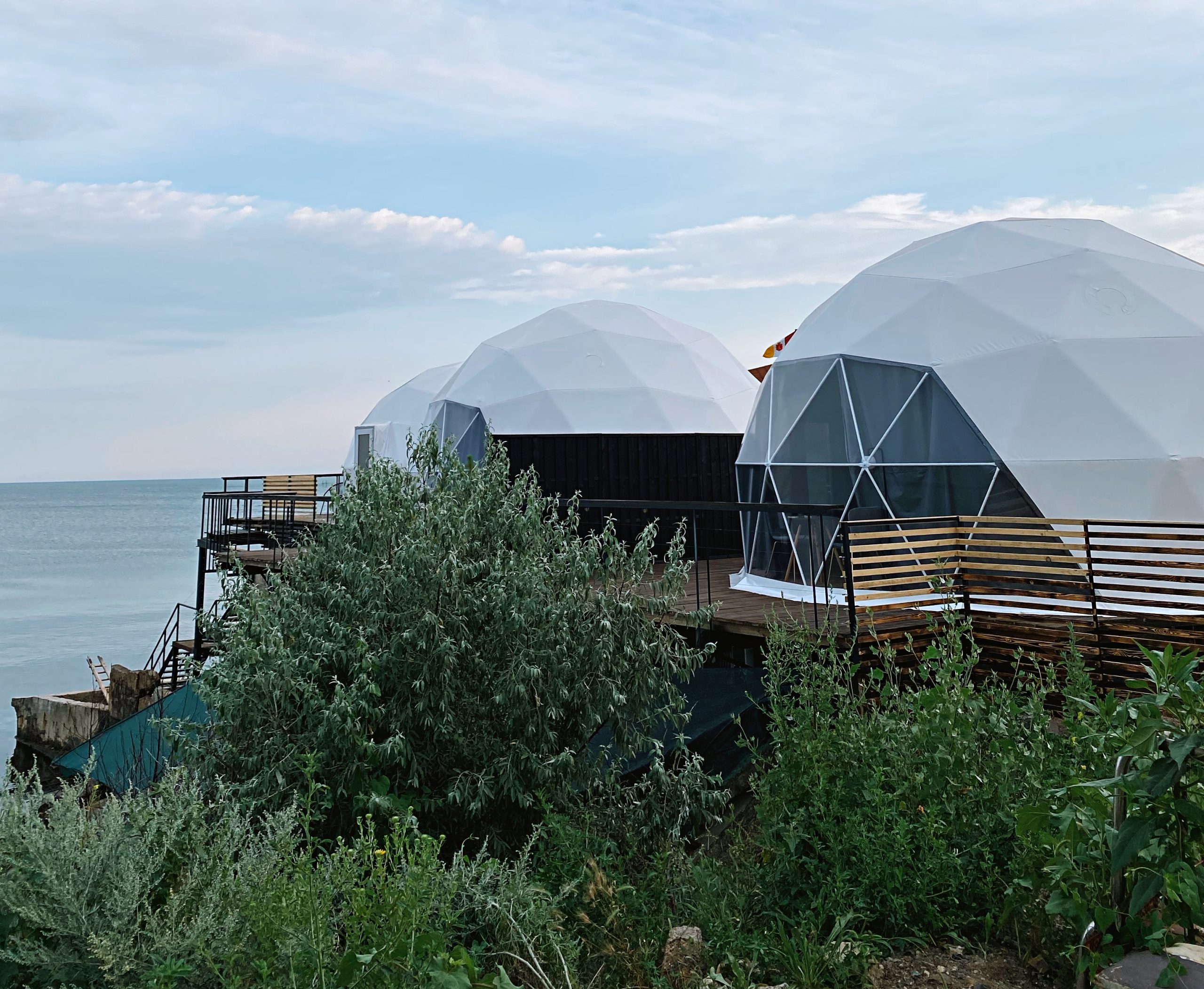 White domes overlooking pale blue sea 