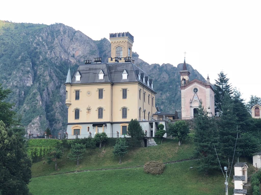 Pastel yellow castle with cliff backdrop