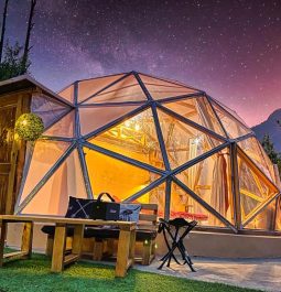 Glass dome overlooking purple and pink sunset views