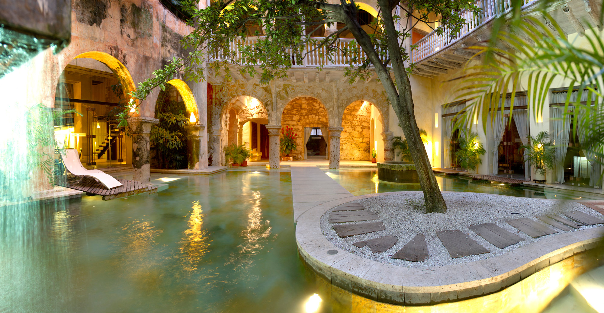 Internal swimming pool surrounded by palm trees