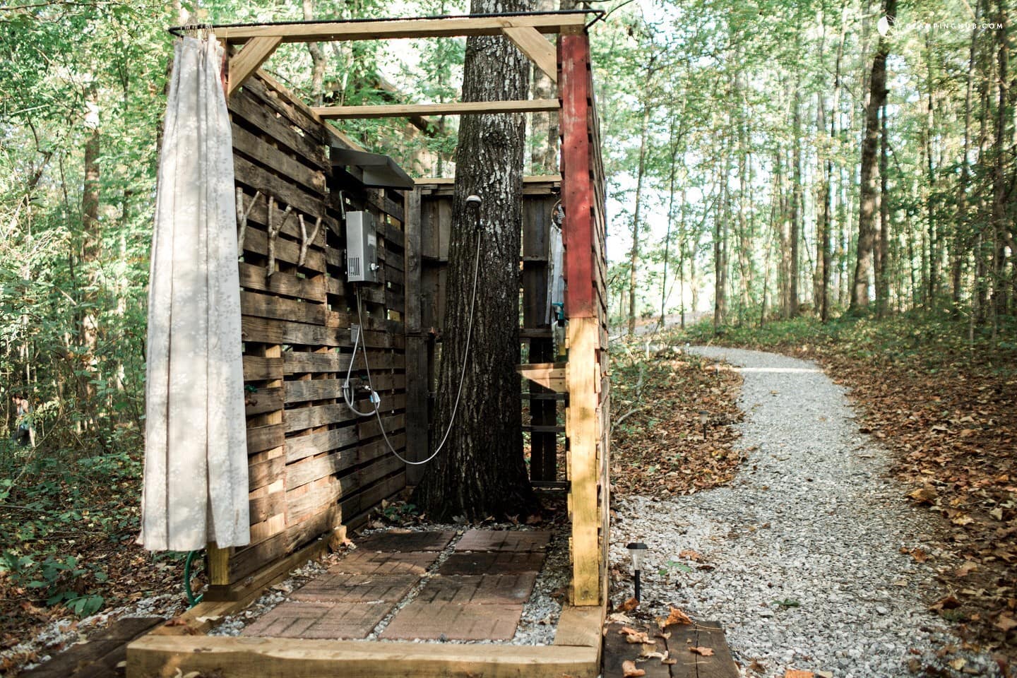 Outdoor shower in middle of wooded forest