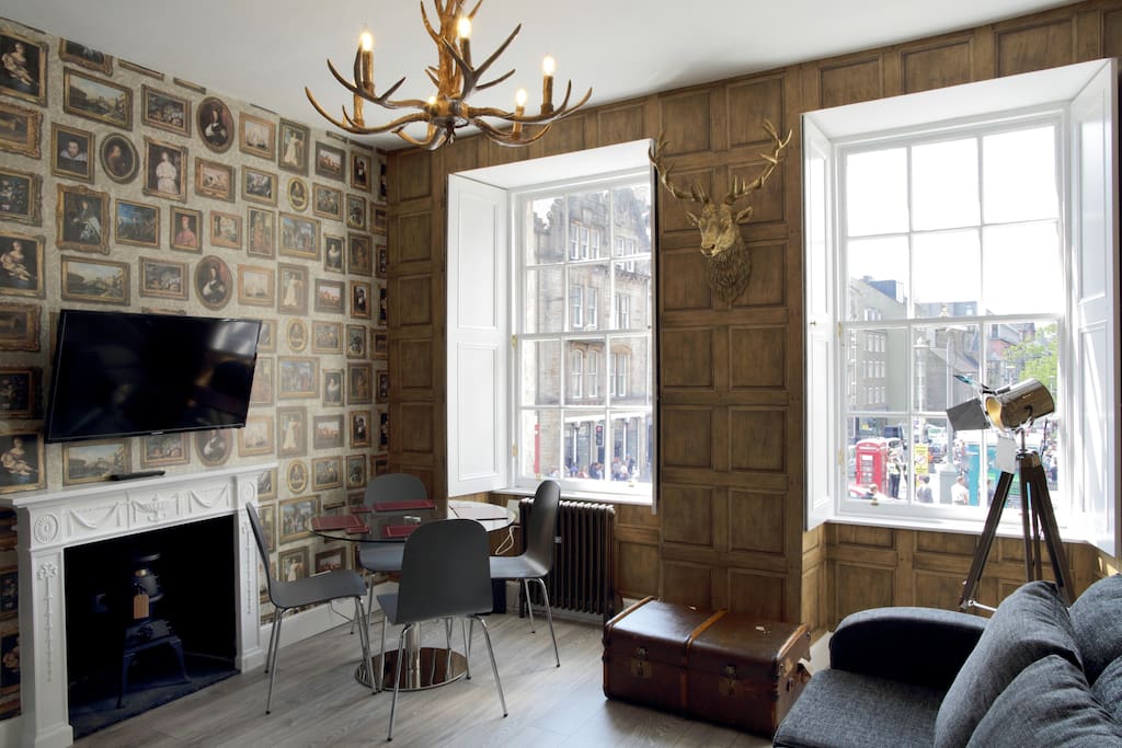 Living room with exposed brick wall and chandelier