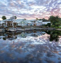 Cool cloud formation reflecting off lake in front of Key West style resort