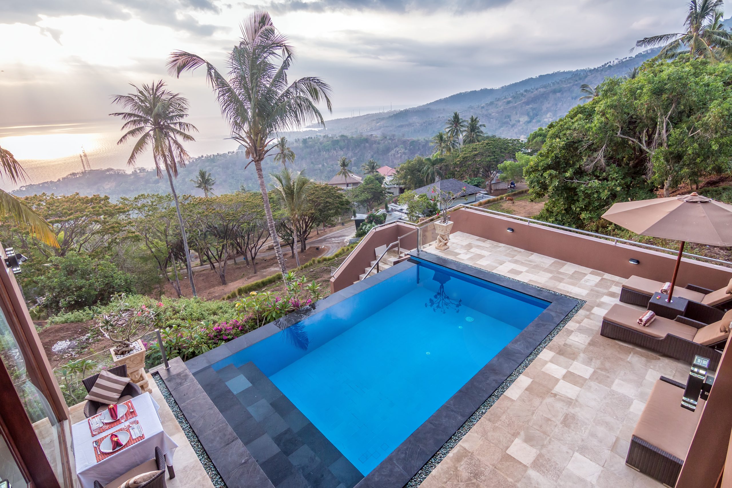 Relax by the infinity pool overlooking the jungle