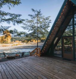 cabin with a large deck overlooking a river