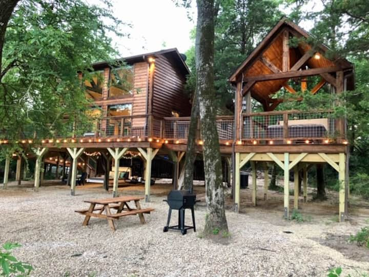 Experience a pond-side treehouse in the woods