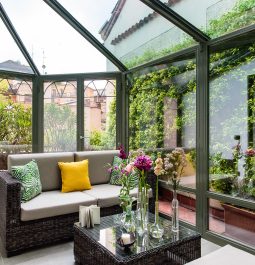 Closed veranda with a sofa and flowers