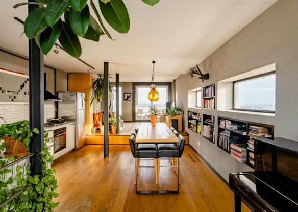 Bright open-space apartment with a dining table and a kitchen corner