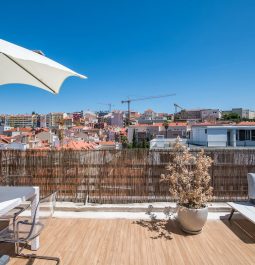 rooftop terrace with picnic table and umbrella